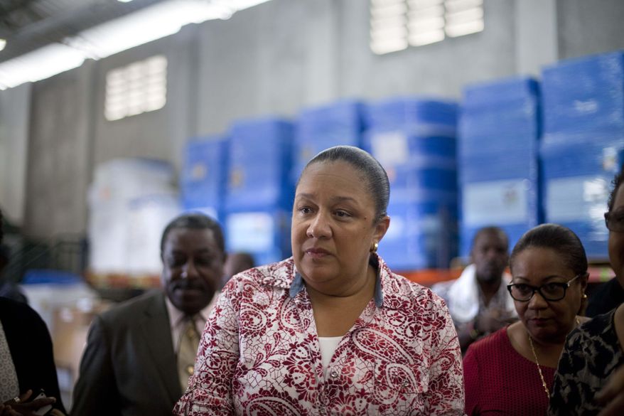 FILE - In this Sept. 10, 2014, file photo, Haiti's first lady Sophia Martelly visits a warehouse housing a donation of kits to treat chikungunya, in the Cite Soleil slum, in Port-au-Prince, Haiti. An elections committee in Haiti has the rejected first lady's bid to run for Senate. Electoral council spokesman Richardson Dumel said Wednesday, May 13, 2015, that the committee would not allow the wife of President Michel Martelly to pursue her candidacy. He did not provide details about the decision. (AP Photo/Dieu Nalio Chery, File)