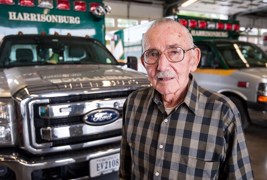 ADVANCE FOR USE MONDAY, MAY 18 - In this photo takan May 5, 2015, Norlyn Senger, 87, the last surviving charter member of Harrisonburg Rescue Squad, poses in the bays of the squad's current station on Reservoir Street in Harrisonburg, Va. Senger was one of the 17 volunteer firemen who formed the rescue squad in September 1949. (Daniel Lin/Daily News-Record via AP)