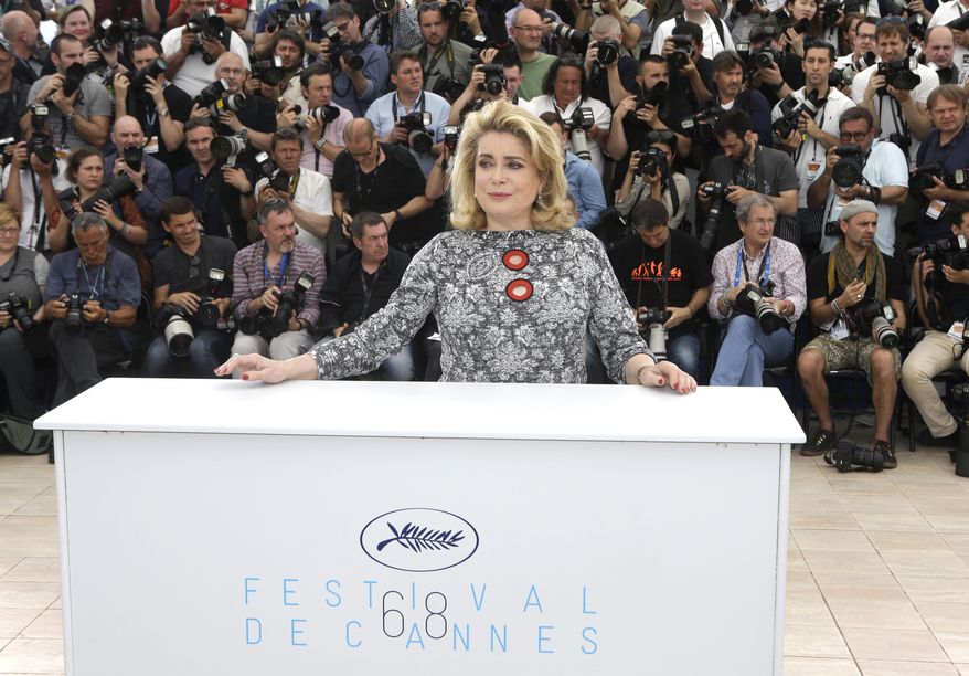 Catherine Deneuve poses for photographers during a photo call for La Tete Haute (Standing Tall), at the 68th international film festival, Cannes, southern France, Wednesday, May 13, 2015. (AP Photo/Lionel Cironneau)