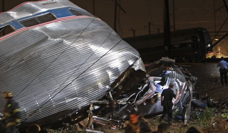 Emergency personnel work the scene of a deadly train wreck, Tuesday, May 12, 2015, in Philadelphia. An Amtrak train headed to New York City derailed and crashed in Philadelphia. (AP Photo/ Joseph Kaczmarek)