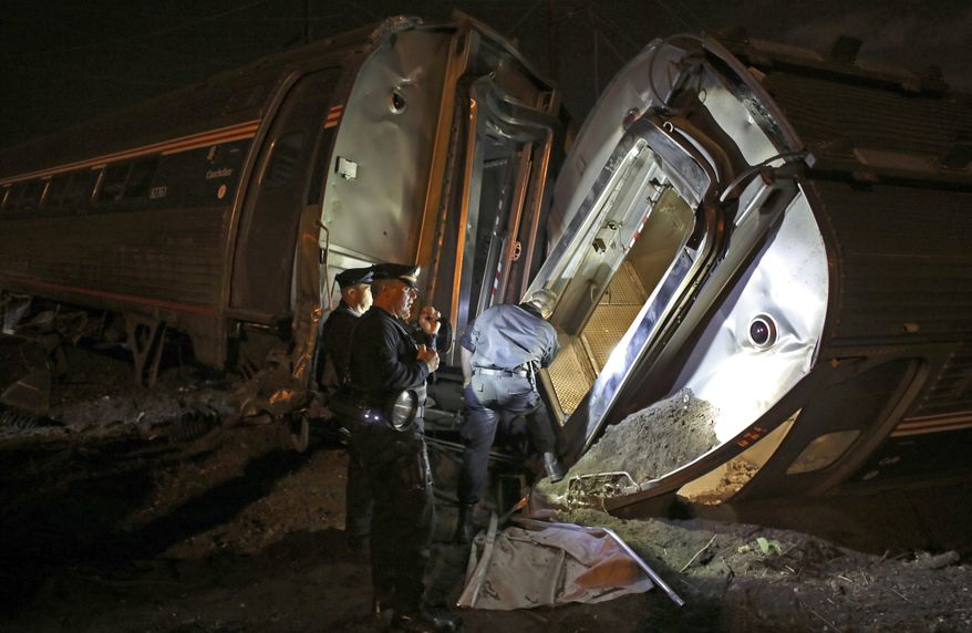 Emergency personnel work the scene of a train wreck, Tuesday, May 12, 2015, in Philadelphia. An Amtrak train headed to New York City derailed and crashed in Philadelphia. (AP Photo/Joseph Kaczmarek)