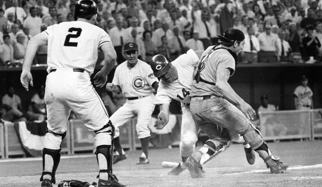 FILE - In this July 14, 1970, file photo, Cincinnati Reds&#x27; Pete Rose slams into Cleveland Indians&#x27; catcher Ray Fosse to score in the 12th inning of the 1970 All-Star Game in Cincinnati, Ohio. Looking on are the Reds&#x27; third base coach Leo Durocher, rear, and Cincinnati Reds&#x27; on-deck batter Dick Dietz (2). Major League Baseball has tried to eliminate those home plate collisions the last few years. MLB Chief Baseball Officer Joe Torre saw the collision from the National League bench and says the hit was clean but devastating to Fosse’s career. (AP Photo/File)