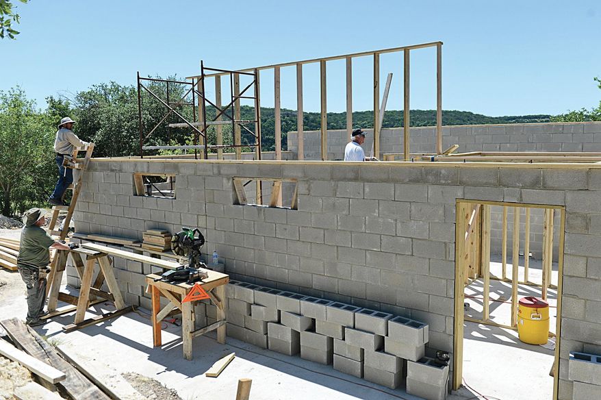 This photo taken May 1, 2015, shows volunteers helping to complete the new toilet facilities at Quiet Valley Ranch, the site of the annual Kerrville Folk Festival. The festival, the longest continually running folk festival in the United States, begins May 21 and continues through June 7 at Quiet Valley Ranch, nine miles south of Kerrville, Texas. (Tom Holden/Kerrville Daily Times via AP)