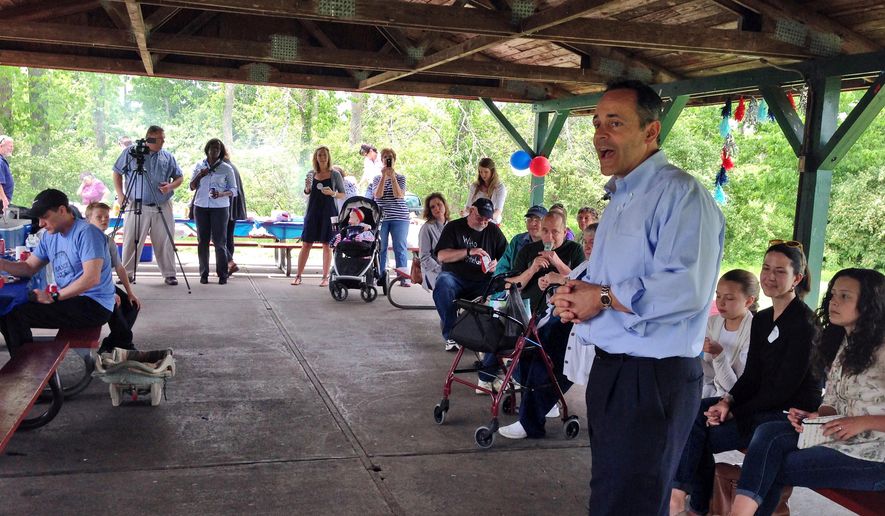 Matt Bevin, right, a candidate in the Republican primary for governor of Kentucky, speaks to a crowd of supporters in Lexington, Ky., Thursday, May 14, 2015. (AP Photo/Adam Beam