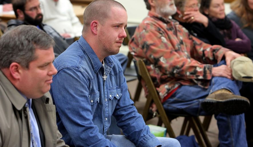 In this photo taken Feb, 25, 2015, Gabriel Steele, reacts after the Burlington Animal Hearing Board in Burlington, Iowa, unanimously decide that the family dog, Sammy, a German shepherd mix, involved in the fatal police shooting of Steele's wife, Autumn, on Jan. 6 is not a vicious or dangerous animal and should be returned. Relatives of the 34-year-old mother who was mistakenly killed by an Iowa police officer, are accusing city and state officials of unfairly withholding evidence gathered during the investigation into her death. (John Lovretta/The Hawk Eye via AP) MANDATORY CREDIT, MAGS OUT