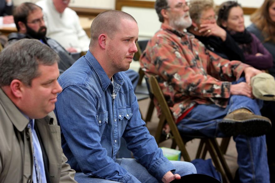 In this photo taken Feb, 25, 2015, Gabriel Steele, reacts after the Burlington Animal Hearing Board in Burlington, Iowa, unanimously decide that the family dog, Sammy, a German shepherd mix, involved in the fatal police shooting of Steele's wife, Autumn, on Jan. 6 is not a vicious or dangerous animal and should be returned. Relatives of the 34-year-old mother who was mistakenly killed by an Iowa police officer, are accusing city and state officials of unfairly withholding evidence gathered during the investigation into her death. (John Lovretta/The Hawk Eye via AP) MANDATORY CREDIT, MAGS OUT