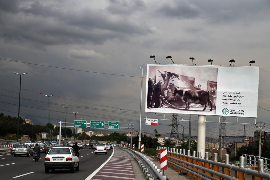 In this photo taken on Sunday, May 10, 2015, cars and motor bikes pass a billboard showing a copy of painting "The Innocent Eye Test" by American artist Mark Tansey from New York Metropolitan Museum, over a highway in Tehran, Iran. In an unusual move by Tehran's mayor, hundreds of copies of famous artworks - both of world masters and Iranian artists - have been plastered on some 1,500 billboards across the city, transforming the Iranian capital into a gigantic, open-air exhibition. (AP Photo/Ebrahim Noroozi)