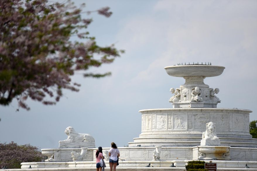 In this photo taken Friday, May 8, 2015, visitors view the James Scott Memorial Fountain on Belle Isle in Detroit. Built between 1921-1925 by architect Cass Gilbert, volunteers are at work preparing the 510-foot wide fountain to begin running from Memorial Day to Labor Day. (Tanya Moutzalias/The Grand Rapids Press via AP) ALL LOCAL TELEVISION OUT; LOCAL TELEVISION INTERNET OUT