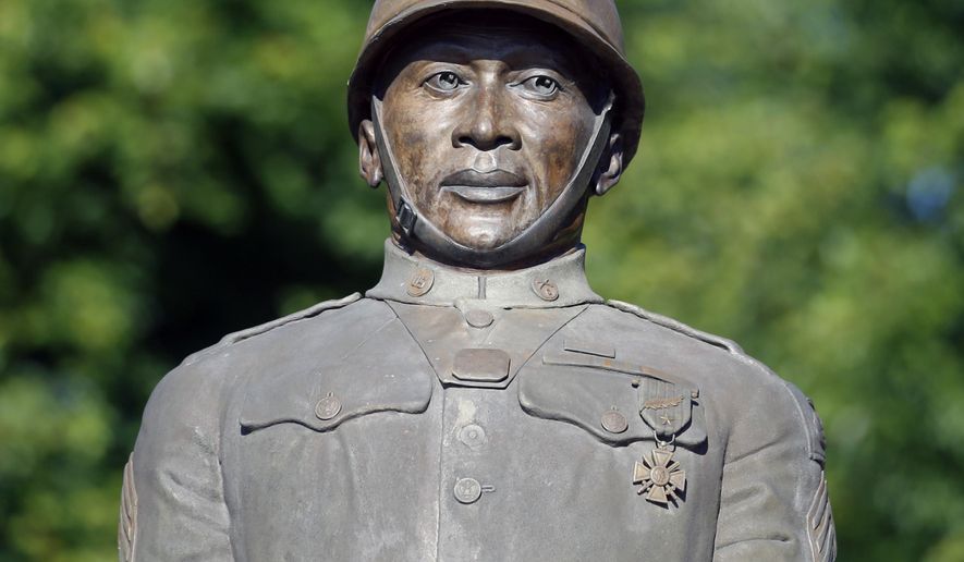 FILE - In this July 10, 2014 file photo, a statue of Henry Johnson is displayed in the Arbor Hill neighborhood in Albany, N.Y. President Barack Obama will award a posthumous Medal of Honor for Johnson during a June 2, 2015 ceremony in Washington. Johnson’s medal was among two approved by Congress after long campaigns to bestow recognition on men who may have been unjustly denied the honor due to discrimination. (AP Photo/Mike Groll, File)