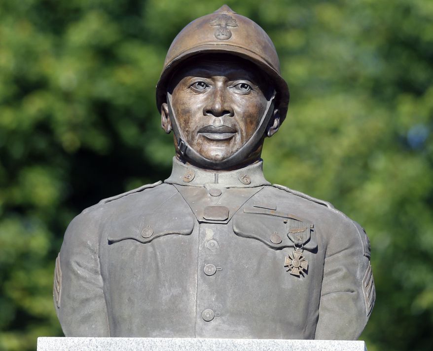FILE - In this July 10, 2014 file photo, a statue of Henry Johnson is displayed in the Arbor Hill neighborhood in Albany, N.Y. President Barack Obama will award a posthumous Medal of Honor for Johnson during a June 2, 2015 ceremony in Washington. Johnson’s medal was among two approved by Congress after long campaigns to bestow recognition on men who may have been unjustly denied the honor due to discrimination. (AP Photo/Mike Groll, File)