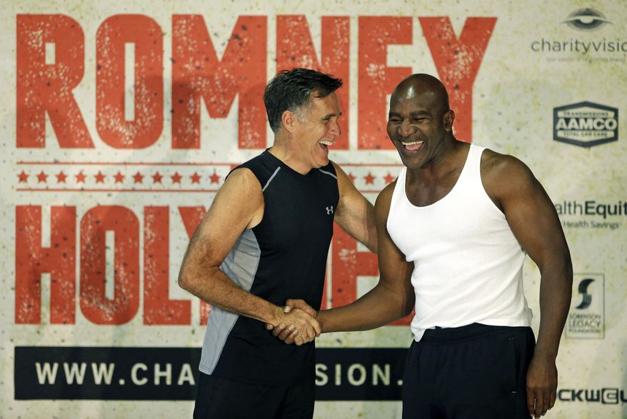 Former Republican presidential candidate Mitt Romney, left, and five-time heavyweight boxing champion Evander Holyfield shake hands after an official weigh-in Thursday, May 14, 2015, in Holladay, Utah. Romney and Holyfield are set to square off at a charity fight on Friday, May 15, in Salt Lake City. (AP Photo/Rick Bowmer)
