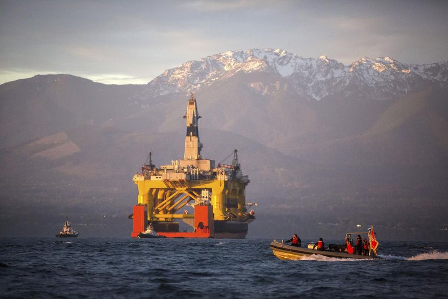 FILE - In this April 17, 2015 file photo, with the Olympic Mountains in the background, a small boat crosses in front of an oil drilling rig as it arrives in Port Angeles, Wash. aboard a transport ship after traveling across the Pacific. Royal Dutch Shell hopes to use the rig for exploratory drilling during the summer open-water season in the Chukchi Sea off Alaska's northwest coast, if it can get the permits. Royal Dutch Shell cleared a major hurdle Monday, May 11, 2015, when The Bureau of Ocean Energy Management approved Shell's exploration plan. However, this isn't the final step that Shell needs for Arctic drilling. (Daniella Beccaria/seattlepi.com via AP, File) MAGS OUT; NO SALES; SEATTLE TIMES OUT; TV OUT; MANDATORY CREDIT