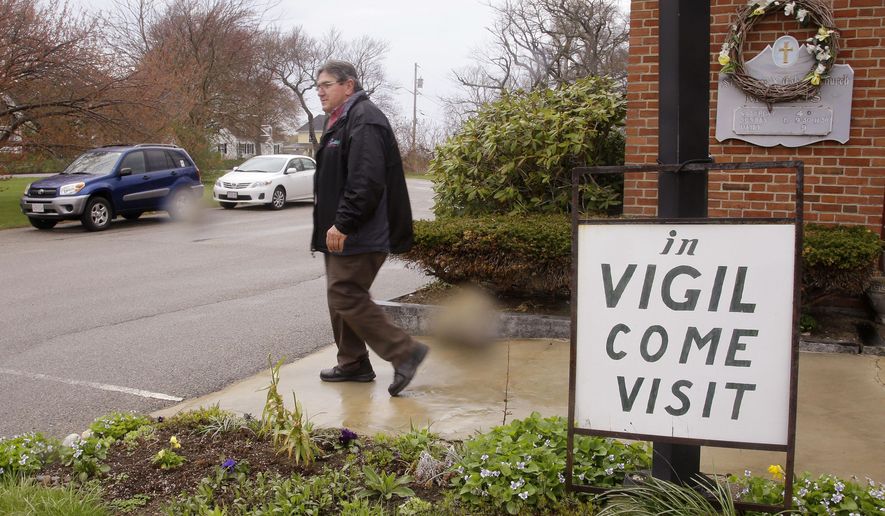 In this Tuesday, May 5, 2015 photo, Marc Dean, a parishioner who has been in vigil at St. Frances Xavier Cabrini Church for the past five years, leaves after his shift is over, in Scituate, Mass. A Massachusetts judge on Thursday, May 14, 2015, has ordered parishioners of the St. Frances Xavier Cabrini Church to end their 11-year protest vigil and vacate the now-closed Roman Catholic church. In his ruling, Superior Court Judge Edward Leibensperger said the parishioners are "unlawfully and intentionally" trespassing at the church in Scituate. (AP Photo/Stephan Savoia)