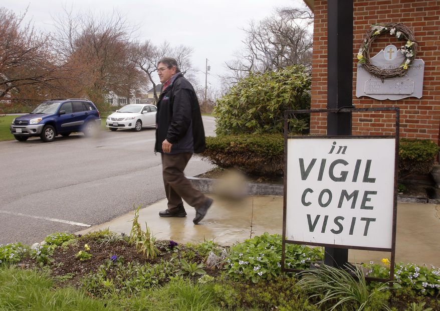 In this Tuesday, May 5, 2015 photo, Marc Dean, a parishioner who has been in vigil at St. Frances Xavier Cabrini Church for the past five years, leaves after his shift is over, in Scituate, Mass. A Massachusetts judge on Thursday, May 14, 2015, has ordered parishioners of the St. Frances Xavier Cabrini Church to end their 11-year protest vigil and vacate the now-closed Roman Catholic church. In his ruling, Superior Court Judge Edward Leibensperger said the parishioners are "unlawfully and intentionally" trespassing at the church in Scituate. (AP Photo/Stephan Savoia)