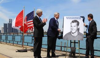 Michigan Gov. Rick Snyder, left, and Canada Prime Minister Stephen Harper and Murray Howe, right, Gordie Howe&#x27;s son, unveil a portrait of the hall of famer during a news conference, Thursday, May 14, 2015, in Windsor, Ontario, announcing that a planned bridge connecting Detroit and Windsor, will be named after the hockey great. The yet-to-be built Gordie Howe International Bridge is expected to be operational in 2020.  (Dave Chidley/The Canadian Press via AP) MANDATORY CREDIT