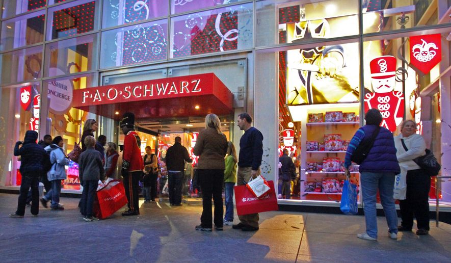 FILE - In this Nov. 21, 2011, file photo, shoppers stand outside of FAO Schwarz in New York. Toys R Us is closing its iconic FAO Schwarz store, citing the high and rising costs of running the retail space on New York City's pricey Fifth Avenue, the company said Friday, May 15, 2015. (AP Photo/Bebeto Matthews, File)