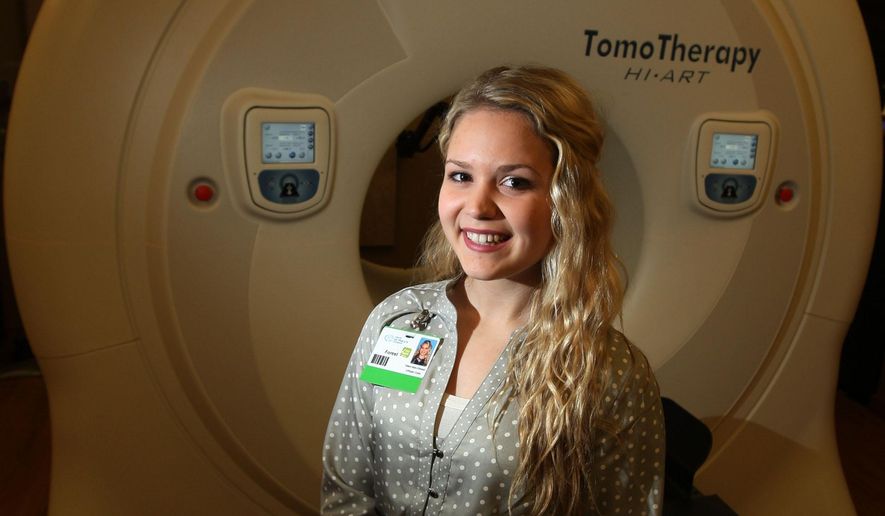 In this Feb. 5, 2015 photo Forest Jacobson, a high school senior and intern at St. Mary’s Cancer Care Center in Decatur, Ill., poses for a photo at the center. Jacobsen is part of a new program called Pathways to Prosperity, in which high school students spend Wednesdays in an internship role in area businesses and their task is to solve a real problem for the business. She wants to go into a medical field but hasn't yet settled on specifics, and no matter what area of medicine she chooses, understanding the patients' perspective will be valuable, said Valerie Jordan, director of oncology services. (Jim Bowling/Herald & Review via AP)
