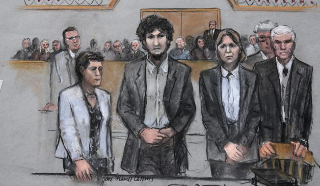 In this courtroom sketch, Boston Marathon bomber Dzhokhar Tsarnaev, center,  stands with his defense attorneys as a death by lethal injection sentence is read at the Moakley Federal court house in the penalty phase of his trial in Boston, Friday, May 15, 2015. The federal jury ruled that the 21-year-old Tsarnaev should be sentenced to death for his role in the deadly 2013 attack. (Jane Flavell Collins via AP)