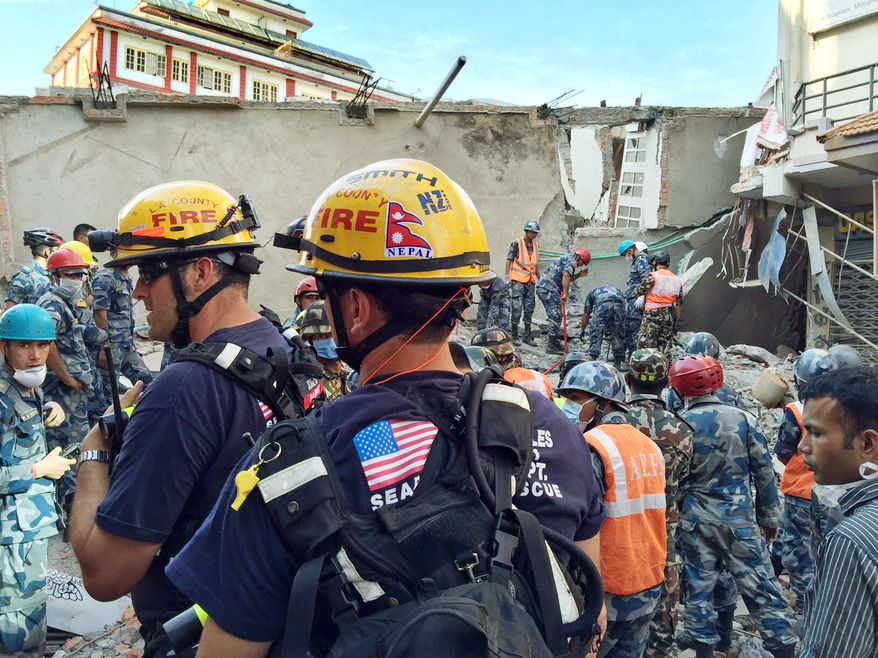 In this May 12, 2015 photo provided by the U.S. Agency for International Development, Los Angeles County Fire Department urban search and rescue team memebrs work to recover survivors from a four-story building that collapsed in this week&amp;#8217;s earthquake in Singati, a mountain village in Nepal. Tuesday&amp;#8217;s temblor was an aftershock to the April 25 main Gorkha earthquake that&amp;#8217;s killed more than 8,000 people. The Disaster Assistance Response Team included 57 urban search and rescuers each from Los Angeles County and Fairfax County, Va. (Kashish Das/USAID/via AP)
