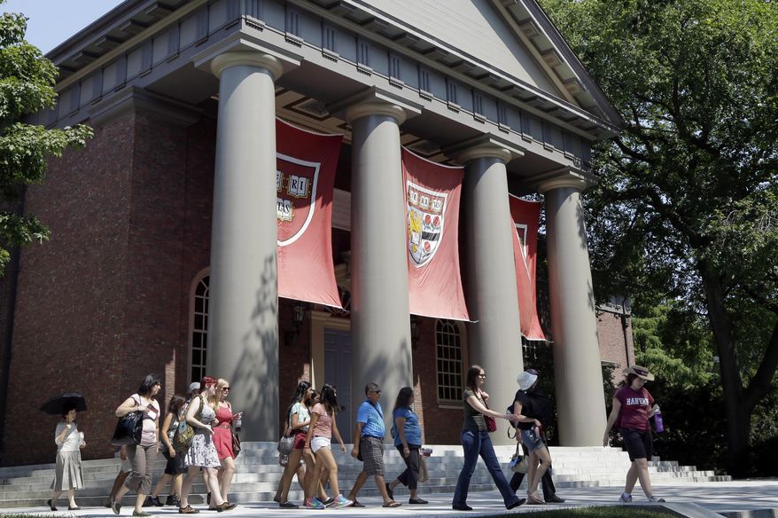 FILE - In this Aug. 30, 2012, file photo, people tour on the campus of Harvard University in Cambridge, Mass. An alliance of Asian American groups on Friday filed a federal complaint against Harvard University, saying that school and other Ivy League institutions are using racial quotas to admit students other than high-scoring Asians. (AP Photo/Elise Amendola, File)
