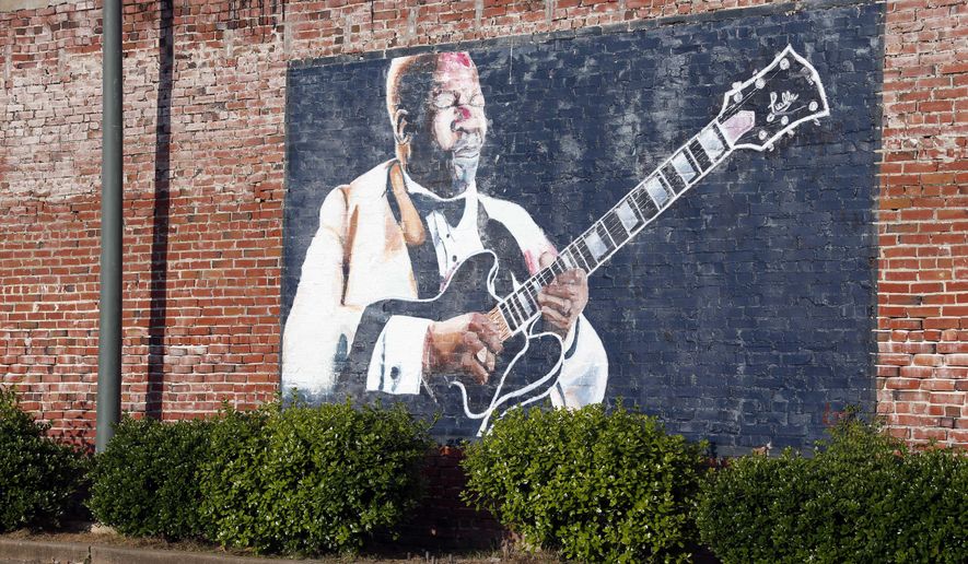In this photo taken May 6, 2015, a wall mural of B.B. King overlooks a downtown parking area in Indianola, Miss. King claimed Indianola as his hometown after moving there as a teenager. The influence of the acclaimed "King of the Blues," is seen throughout the small Mississippi Delta town. King died Thursday night, May 14, 2015, at age 89 in Las Vegas, where he had been in hospice care. (AP Photo/Rogelio V. Solis)