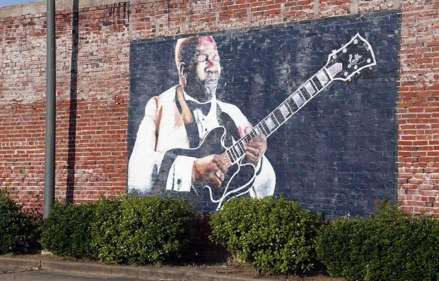 In this photo taken May 6, 2015, a wall mural of B.B. King overlooks a downtown parking area in Indianola, Miss. King claimed Indianola as his hometown after moving there as a teenager. The influence of the acclaimed "King of the Blues," is seen throughout the small Mississippi Delta town. King died Thursday night, May 14, 2015, at age 89 in Las Vegas, where he had been in hospice care. (AP Photo/Rogelio V. Solis)