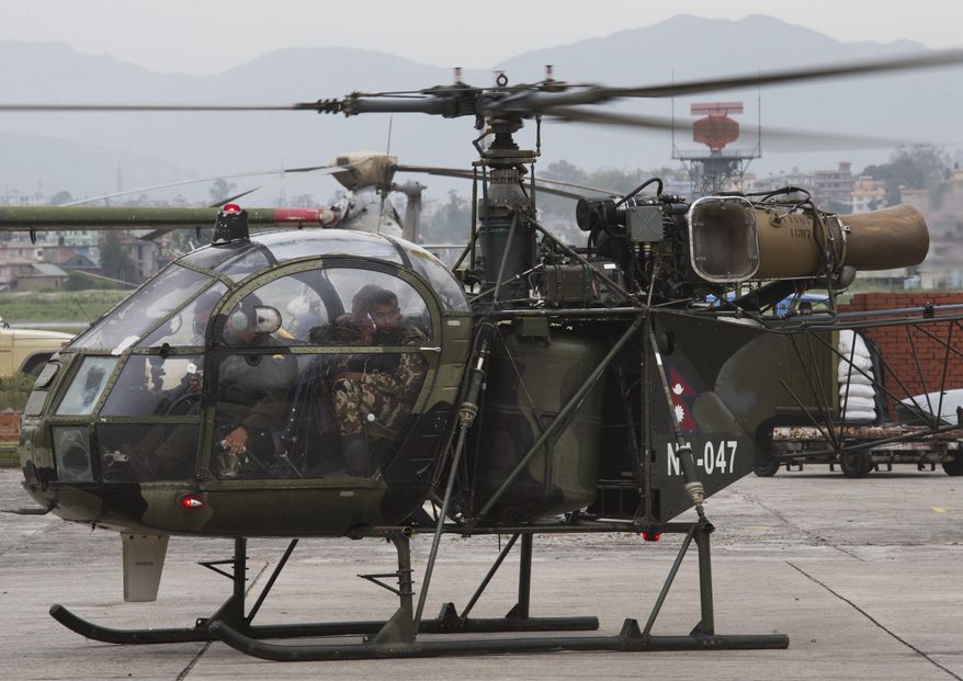 A Nepalese army chopper, that spotted the suspected wreckage of a U.S. Marine helicopter, lands at the airport in Kathmandu, Nepal, Friday, May 15, 2015. Nepalese rescuers on Friday found three bodies near the wreckage of the chopper that was carrying six Marines and two Nepalese army soldiers. The U.S. Marines said they were sending their own rescue team to assess the wreckage and determine if it was the missing helicopter, the UH-1 "Huey." (AP Photo/Bernat Armangue)