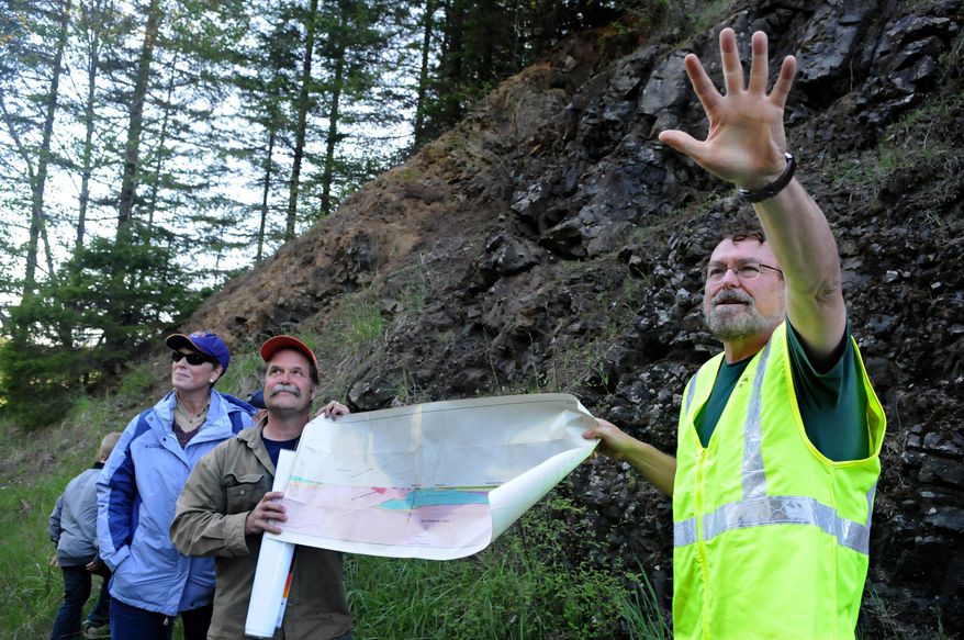 In this May 7, 2015, photo, Oregon State University emeritus geology professor Bob Lillie, right, explains the origins of volcanic rock formations on Marys Peak in Benton County, Ore. (Amanda Cowan/The Corvallis Gazette-Times via AP)