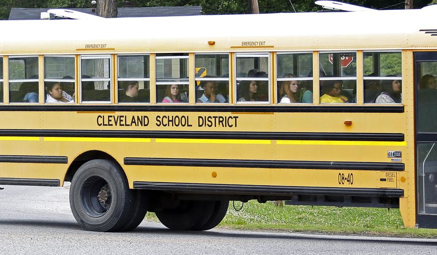 In this May 13, 2015 photo, an integrated group of Cleveland, Miss., public school students ride the bus on their way home following classes. On Monday, May 18, a five-day federal court hearing starts in Jackson and could settle whether Cleveland's two middle schools and two high schools are merged as one each as part of a 49-year-old desegregation lawsuit. (AP Photo/Rogelio V. Solis)