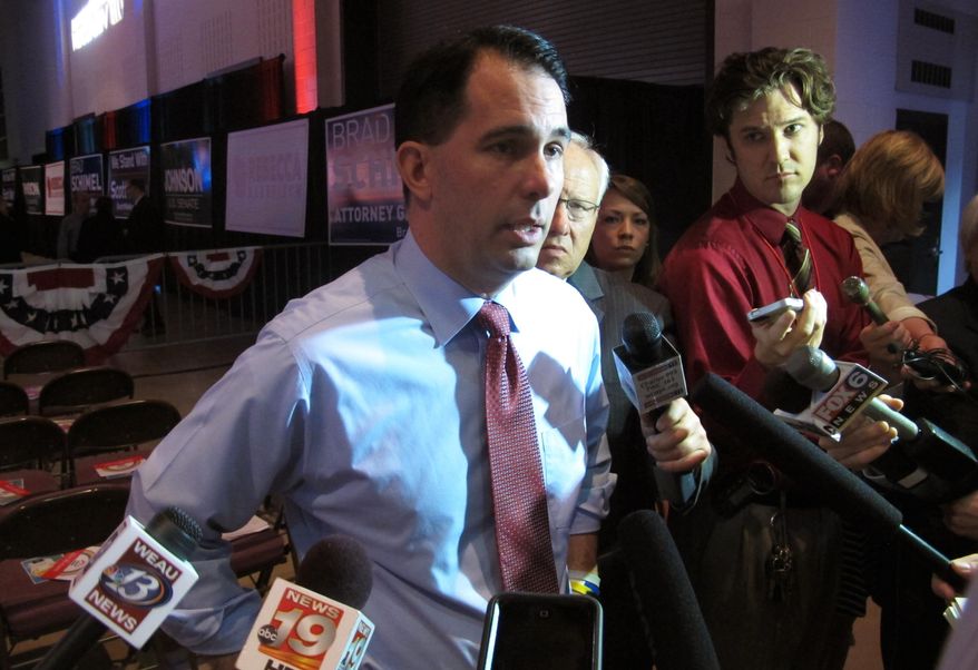 Gov. Scott Walker takes questions before his speech at the Wisconsin Republican Party convention on Saturday, May 15, 2015, in La Crosse, Wis. Breaking with tradition, Walker spoke to about 1,000 people at the center of the convention floor, rather than from the stage. Walker did not make reference to his own likely presidential run. But he did call on conference attendees to work to help Republicans win the White House next year. No Republican for president has carried Wisconsin since 1984. (AP Photo/Scott Bauer)