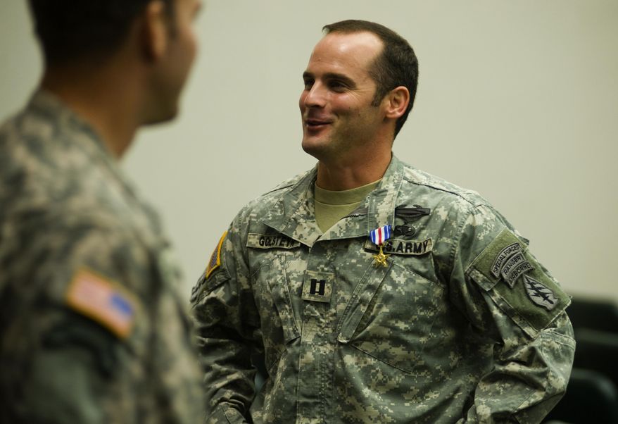 In this photo taken Jan. 4, 2011, U.S Army Capt. Mathew Golsteyn is congratulated by fellow soldiers following the Valor Awards ceremony for 3rd Special Forces Group at Fort Bragg, N.C.  Golsteyn, stripped of a medal for heroism under fire and his right to call himself a Green Beret is fighting for his military career after accusations he tracked down and killed a suspected bomb-maker in Afghanistan.  Though a criminal investigation failed to find remains of his alleged victim and didn’t result in charges against  Golsteyn, he’s been targeted for possible dismissal from the Army and the consequent loss of veteran’s benefits with a less-than-honorable discharge.  (James Robinson/The Fayetteville Observer via AP) MANDATORY CREDIT, MAGS OUT. NO SALES.