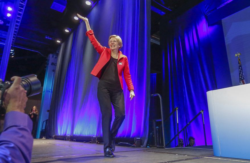 U.S. Sen. Elizabeth Warren, D-Mass., waves as she arrives at the California Democrats State Convention in Anaheim, Calif., on Saturday, May 16, 2015. (AP Photo/Damian Dovarganes)