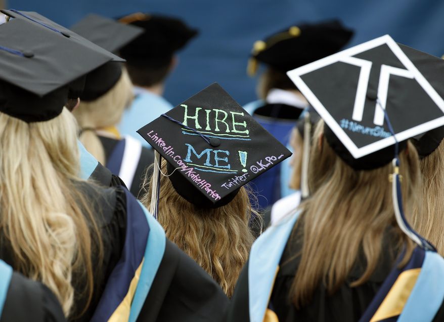 George Washington University graduates, including one looking for a job, are seated during the school's commencement exercises on the National Mall, Sunday, May 17, 2015 in Washington. (AP Photo/Alex Brandon) ** FILE **