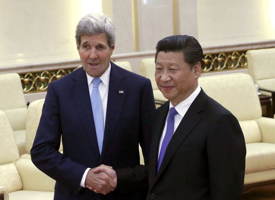 U.S. Secretary of State John Kerry, left, shakes hands with Chinese President Xi Jinping at the Great Hall of the People at the Great Hall of the People in Beijing, China, Sunday, May 17, 2015.  Kerry was meeting Sunday with Chinese President Xi before heading to South Korea to complete a short Asian tour that has been clouded so far by concerns over China&#x27;s construction in South China Sea. (Kim Kyung-Hoon/Pool Photo via AP)