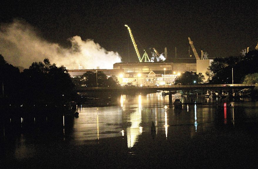 FILE - In this Wednesday, May 23, 2012 file photo, smoke rises from a dry dock as fire crews respond to a fire on the USS Miami submarine (SSN 755) at the Portsmouth Naval Shipyard on an island, in Kittery, Maine. Casey Fury, who is serving 17 years in prison for the fire, says he made a false confession under the threat of a life sentence. He says his confession was false and coerced and wants to ask a judge to reconsider his sentence. The fire caused $700 million in damage and the attack submarine was ultimately scrapped. (AP Photo/The Herald, Ionna Raptis, File)