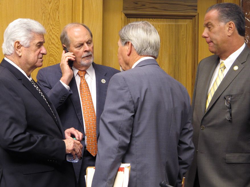 Senate leaders speak with sponsors of two House tax bills that received easy passage from the Senate Revenue and Fiscal Affairs Committee on Monday, May 18, 2015, in Baton Rouge, La. Those assembled from left to right are: Senate President John Alario, R-Westwego; Senate Finance Committee Chairman Jack Donahue, R-Mandeville; Rep. Harold Ritchie, D-Bogalusa; and Rep. Bryan Adams, R-Gretna. (AP Photo/Melinda Deslatte)