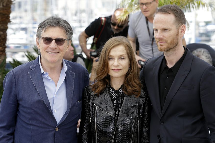 From left, actors Gabriel Byrne, Isabelle Huppert, and director Joachim Trier pose for photographers during a photo call for the film Louder than Bombs, at the 68th international film festival, Cannes, southern France, Monday, May 18, 2015. (AP Photo/Lionel Cironneau)