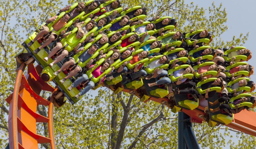 This photo provided by Cedar Point in Sandusky, Ohio, shows the theme park’s new Rougarou roller coaster. The floorless coaster has a werewolf theme. It’s one of a number of new attractions at theme parks around the country this summer. (AP Photo/Cedar Point)