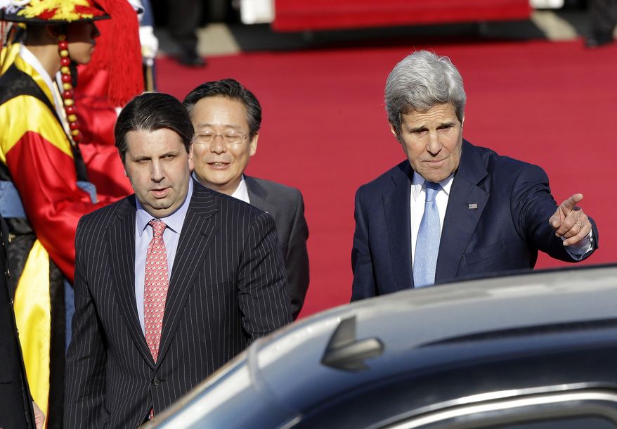 U.S. Secretary of State John Kerry, right, and U.S. Ambassador to South Korea Mark Lippert walk to a car upon his arrival from China, at the Seoul Military Airport in Seongnam, South Korea, Sunday, May 17, 2015. (AP Photo/Ahn Young-joon)