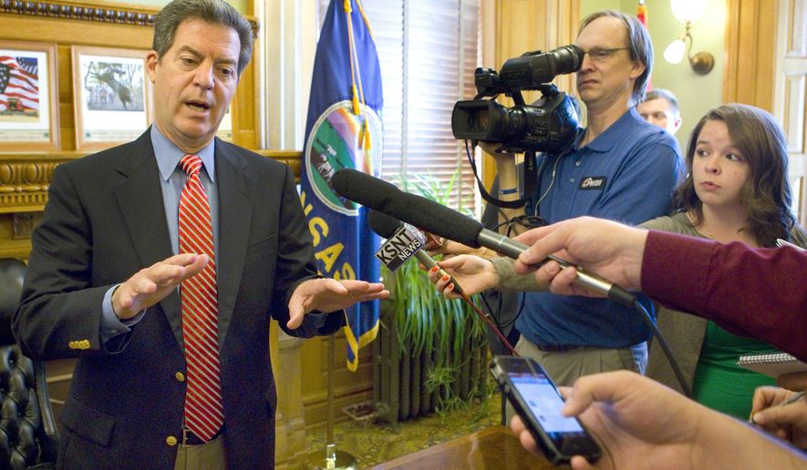 Kansas Gov. Sam Brownback speaks to the media Monday, May, 18, 2015, after signing a bill in his ceremonial office. When asked about his use of a private email the governor said that he has engaged in the practice since he was a U.S. senator. "I just thought, well, look, 'I'll just use the personal one and pay for that myself”. (Thad Allton/Topeka Capital-Journal via AP)