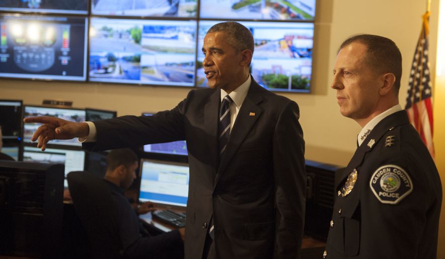 President Obama tours the Real-Time Tactical Operational Intelligence Center in the Camden County (N.J.) Police Administration Building on Monday with Camden County Police Chief J. Scott Thomson. (Associated Press)