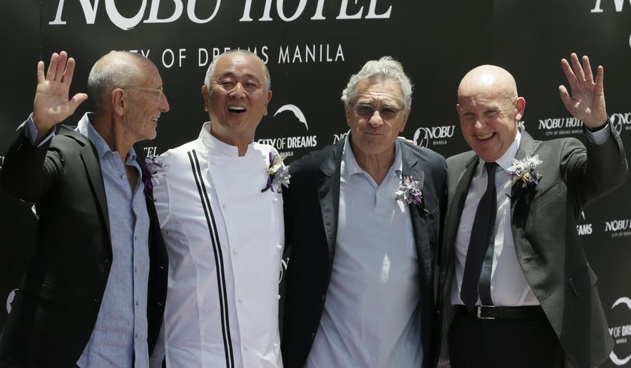 From right, Trevor Horwell, CEO of Nobu Hospitality, Hollywood actor Robert De Niro, Japanese culinary Chef Nobu Matsuhisa and Hollywood film producer Meir Teper pose during the ribbon-cutting ceremony at the opening of the Nobu Hotel at the City of Dreams Casino Monday, May 18, 2015 at suburban Pasay city, south of Manila, Philippines. Robert de Niro and his business partners have formally opened Asia's first Nobu Hotel in Manila as the luxury brand gears up for global expansion.(AP Photo/Bullit Marquez)