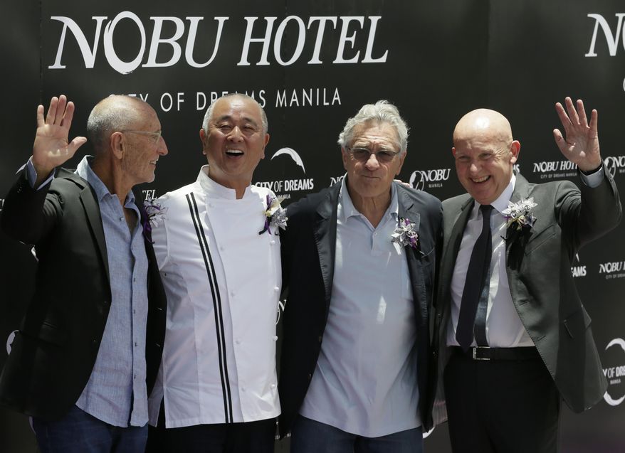 From right, Trevor Horwell, CEO of Nobu Hospitality, Hollywood actor Robert De Niro, Japanese culinary Chef Nobu Matsuhisa and Hollywood film producer Meir Teper pose during the ribbon-cutting ceremony at the opening of the Nobu Hotel at the City of Dreams Casino Monday, May 18, 2015 at suburban Pasay city, south of Manila, Philippines. Robert de Niro and his business partners have formally opened Asia's first Nobu Hotel in Manila as the luxury brand gears up for global expansion.(AP Photo/Bullit Marquez)