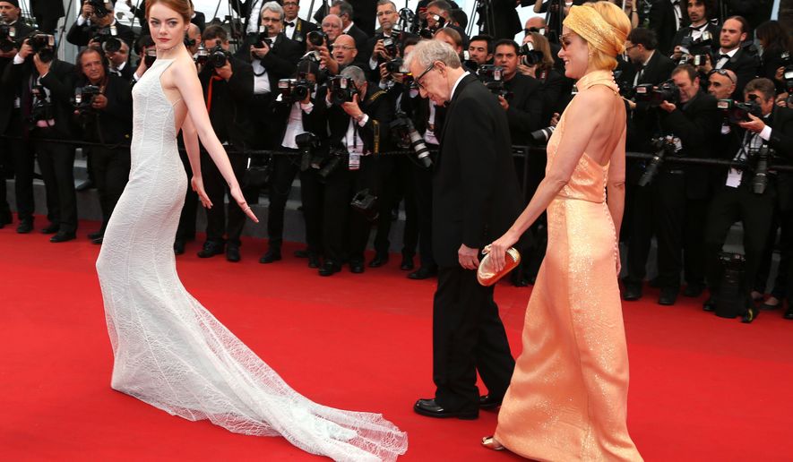 Actress Emma Stone, director Woody Allen and Parker Posey pose for photographers on the red carpet at the screening of the film Irrational Man at the 68th international film festival, Cannes, southern France, Friday, May 15, 2015. (AP Photo/Thibault Camus)