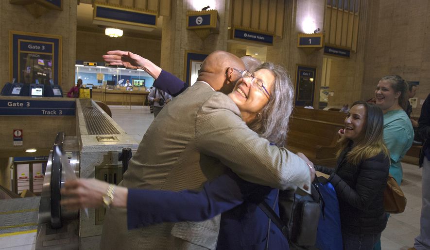 Philadelphia Mayor Michael Nutter hugs Mary Schaheen, the first passenger in line for Train 110 at Philadelphia&#39;s 30th Street Station, Monday, May 18, 2015, as Amtrak trains began rolling on the busy Northeast Corridor early Monday, the first time in almost a week following a deadly crash in Philadelphia. (AP Photo/Michael R. Sisak)