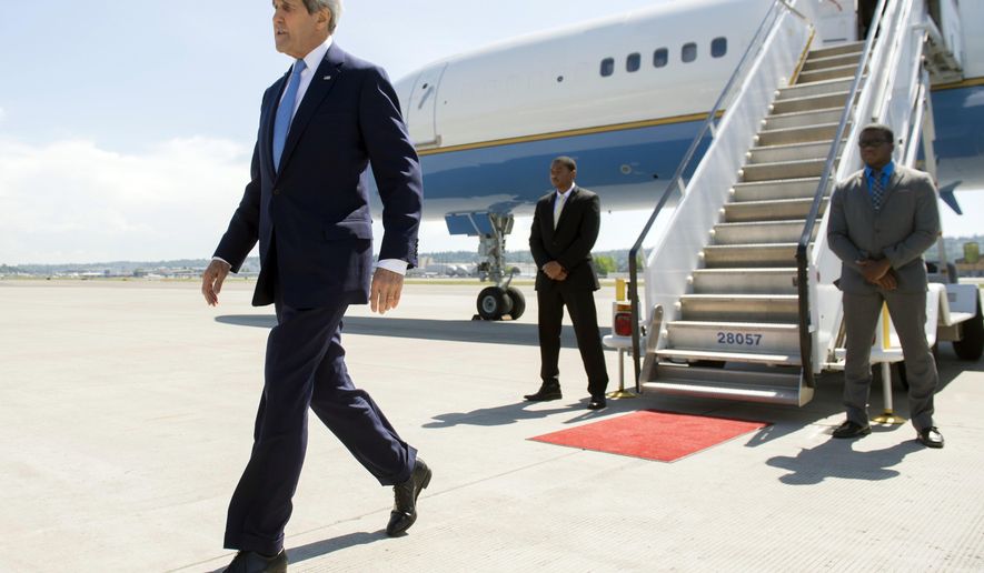 US Secretary of State John Kerry disembarks from his airplane upon arrival at Boeing Field in Seattle, Washington, Monday, May 18, 2015. Kerry returned to the US following a 3-day trip to China and South Korea. (Saul Loeb/Pool Photo via AP)