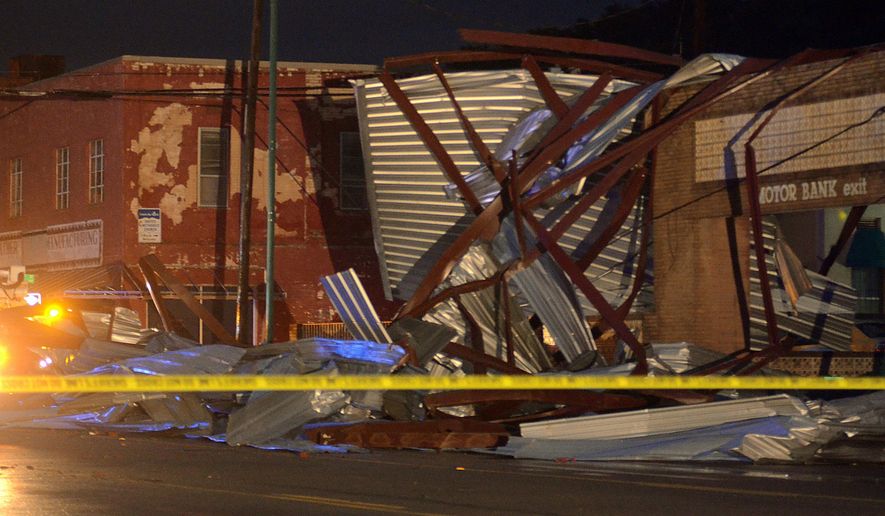 Debris from the roof of the Poston Building lies on an abandoned bank after a tornado went through the area in Mineral Wells, Texas, Tuesday, May 19, 2015. Moderate damage was widespread, but emergency officials say the worst damage appeared to be downtown. (Bob Haynes/The Fort Worth Star-Telegram via AP) MAGS OUT
