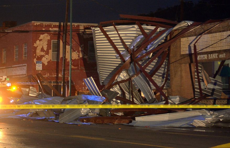 Debris from the roof of the Poston Building lies on an abandoned bank after a tornado went through the area in Mineral Wells, Texas, Tuesday, May 19, 2015. Moderate damage was widespread, but emergency officials say the worst damage appeared to be downtown. (Bob Haynes/The Fort Worth Star-Telegram via AP) MAGS OUT