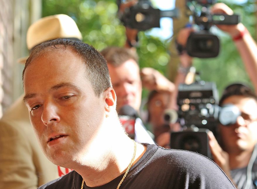 FILE- In this May 11, 2015 file photo, Matthew Apperson, who authorities say was involved in a shooting incident involving George Zimmerman, enters the Lake Mary Police Department with his attorney in Lake Mary, Fla. A police report says Apperson, charged with shooting at George Zimmerman on May 11, had “a fixation” on the former neighborhood watch leader. The report made public Tuesday, May 19, 2015, also says 36-year-old Matthew Apperson had recently been admitted to a mental institution and had shown signs of paranoia, anxiety and bipolar disorder (Red Huber/Orlando Sentinel via AP, File)