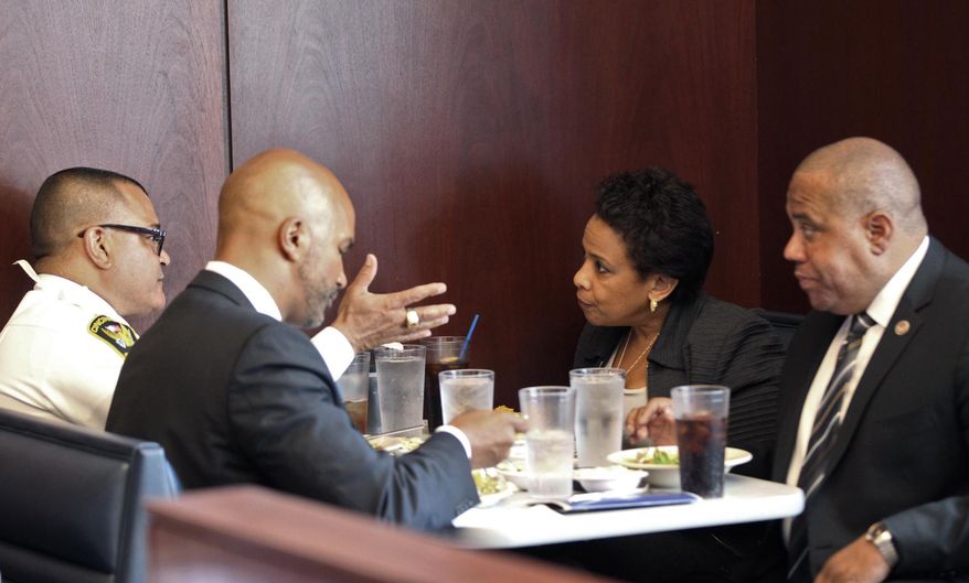 From left: Cincinnati Chief of Police Jeffrey Blackwell, U.S.Attorney for the Southern District of Ohio Carter M. Stewart, U.S. Attorney General Loretta Lynch and Director of Community Oriented Policing Services Ron Davis, eat lunch in downtown Cincinnati, Tuesday, May 19, 2015. Lynch began a national tour highlighting collaborative programs and policing practices designed to improve public safety and strengthen police-community relations. The Justice Department says the tour is intended to promote $163 million in grants available to build on President Barack Obama's commitment to work with law enforcement and others to implement recommendations from the 21st Century Policing Task Force report. (Kareem Elgazzar/The Cincinnati Enquirer via AP) MANDATORY CREDIT; NO SALES
